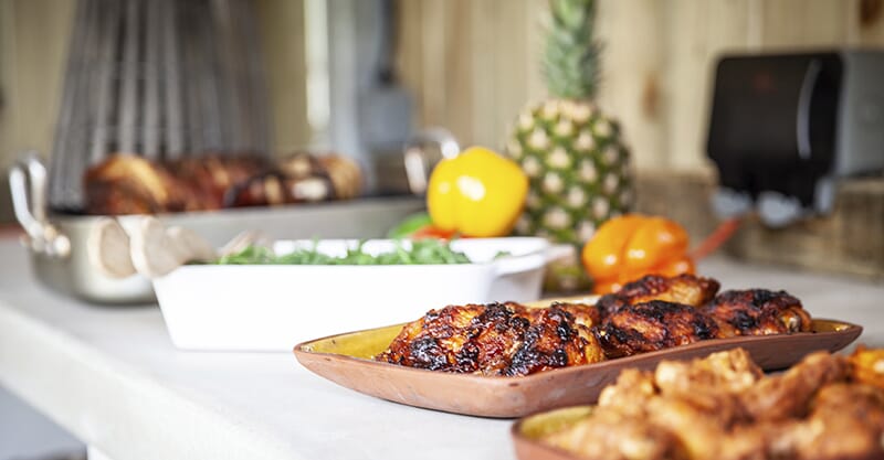 Elegant kitchen garden design in the Cotswolds by Keltie & Clark, featuring a stylish outdoor dining setup with natural wood and greenery.