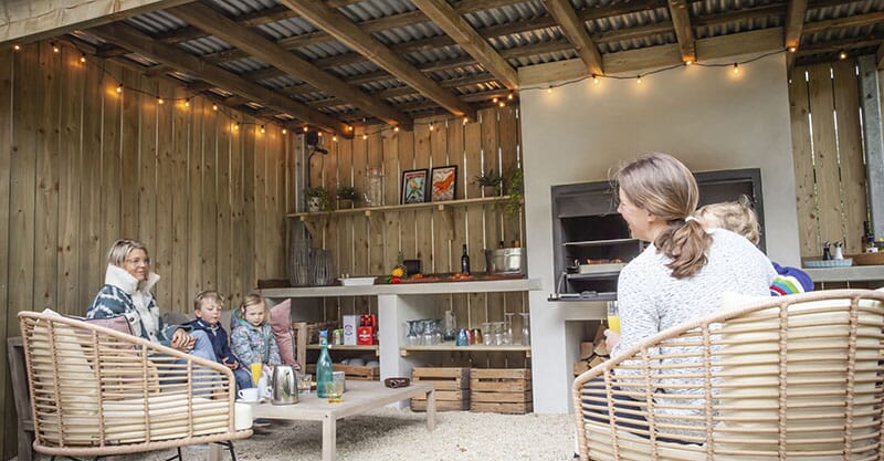 Chic outdoor dining space in a kitchen garden by Keltie & Clark, showcasing a blend of rustic charm and modern design in the Cotswolds.