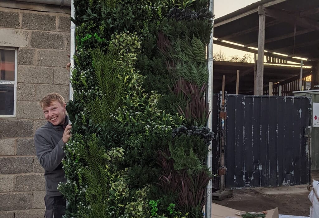 Putting together a vertical garden for a client by Gardens by Keltie & Clark